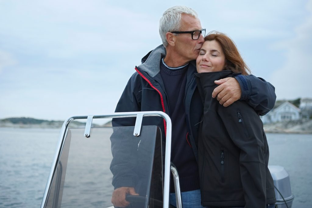 Middle aged couple on motor boat